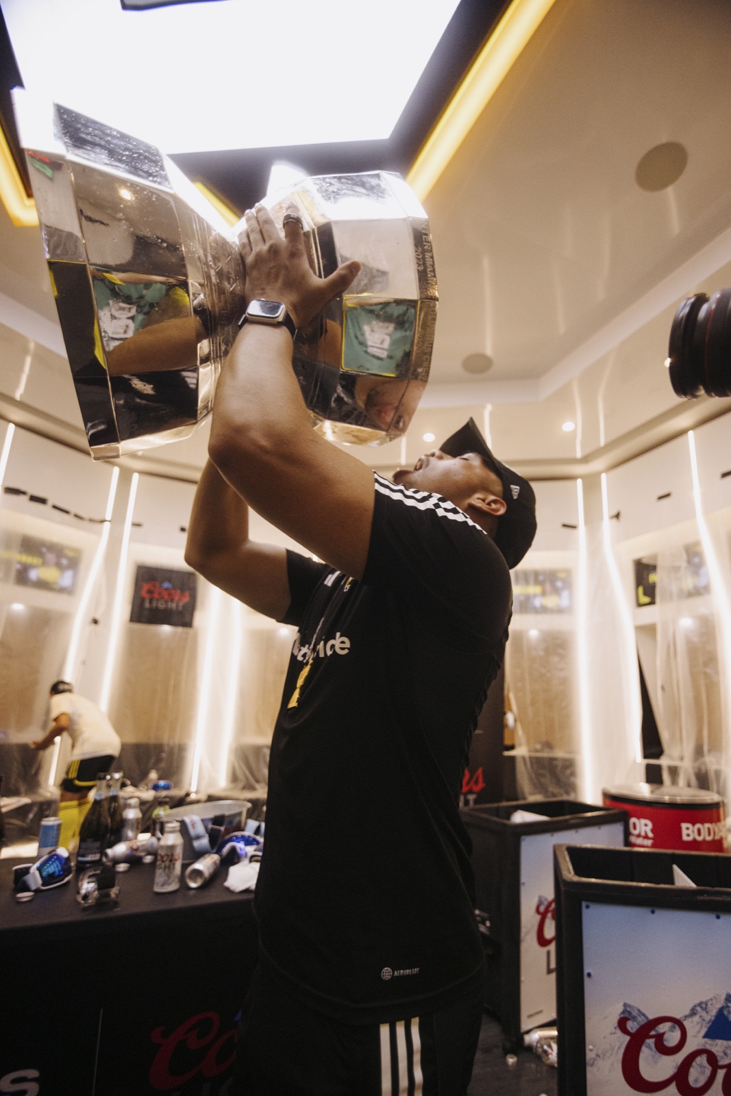 Luis celebrating with the Leagues Cup trophy inside the Columbus Crew locker room